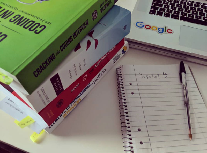 Get those interview books ready and let's kick some ass! A bunch of books to prepare the programming interview and a notebook with a pep message in it. You got this!