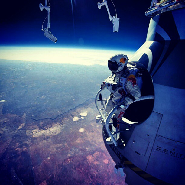 Felix Baumgartner sitting on the capsule in the Stratosphere just about to jump